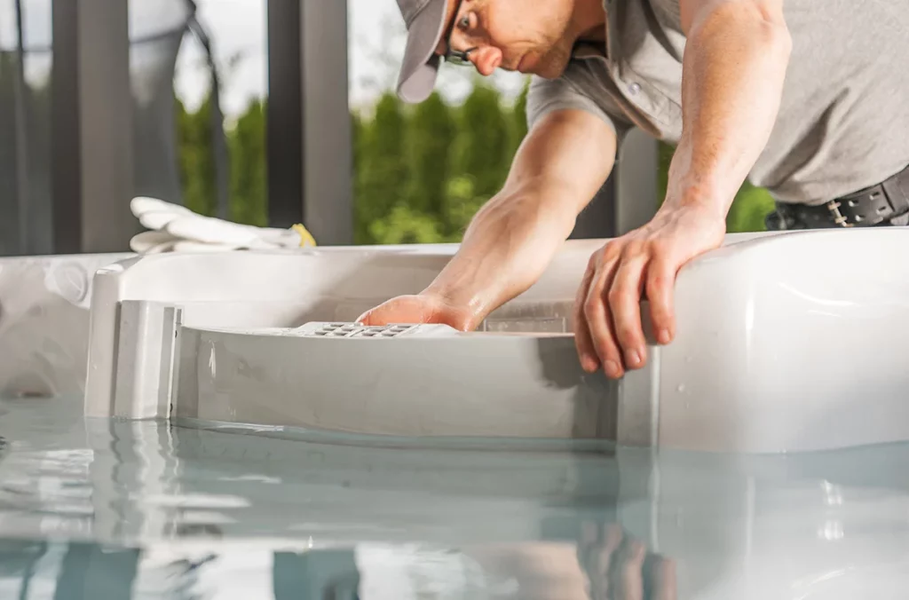 A professional hot tub technician helping with hot tub maintenance or repair