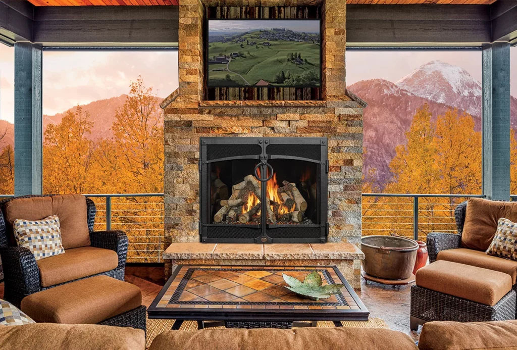 An outdoor fireplace and seating area with a mountain view background during fall