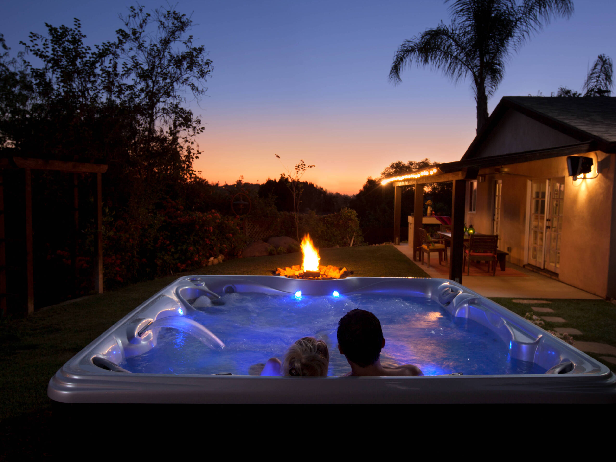 Couple enjoying a beautiful sunset from the comfort of their hot tub