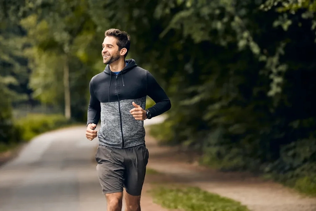 A smiling jogger on a run, showing the concept of heart health as a benefit of infrared saunas